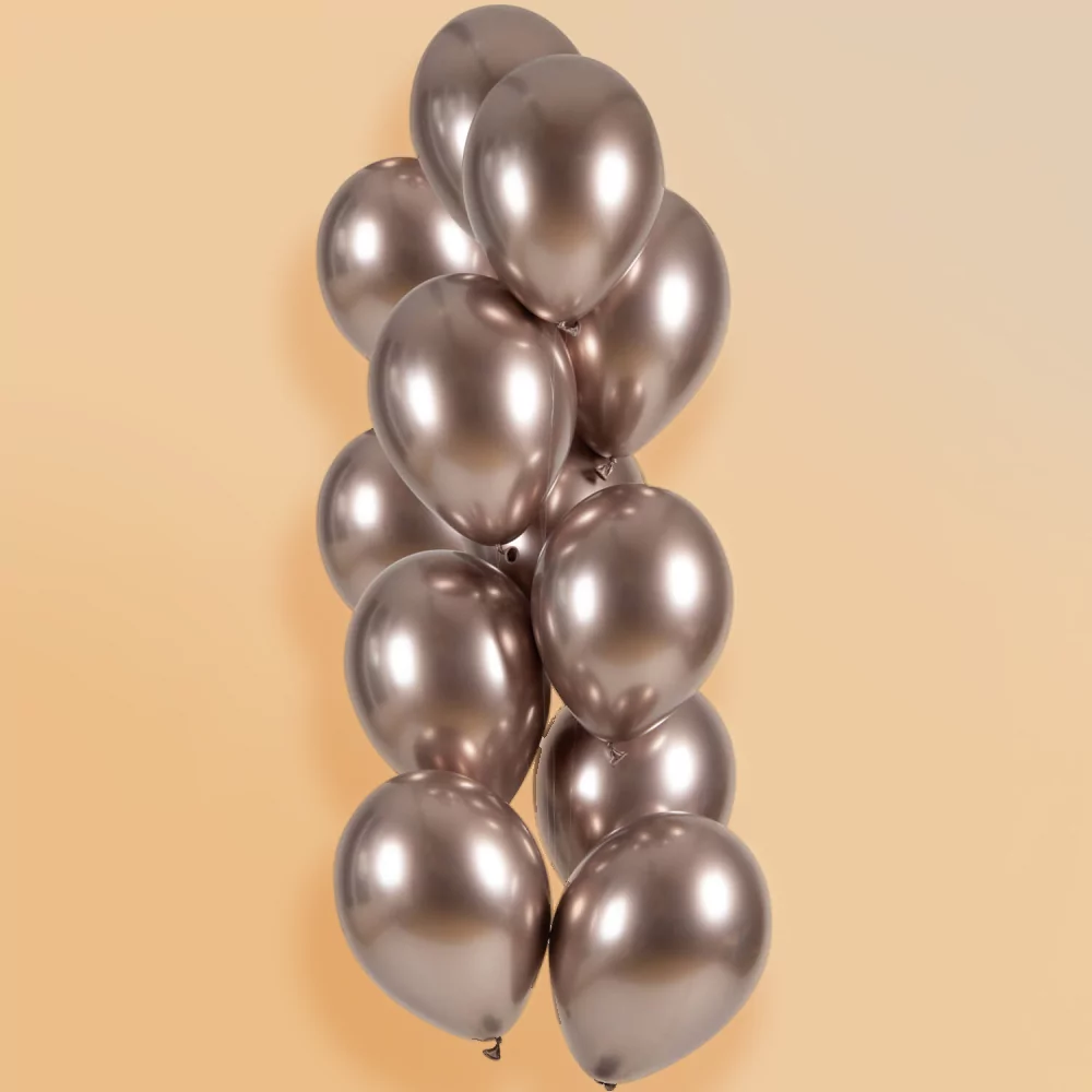 rose gouden chrome ballonnen voor een perzikkleurige achtergrond