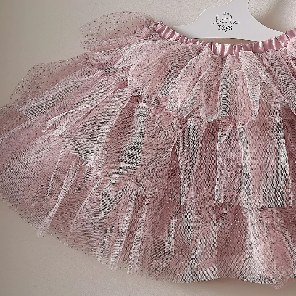 roze tutu met zilveren diamantjes hangt aan een witte kledinghanger